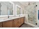 Luxurious bathroom with double vanity, decorative tile shower, and modern fixtures, offering a spa-like experience at 245 Tumbling River Dr, Wendell, NC 27591