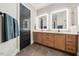Bright bathroom features a double vanity with modern undermount sinks and a black door at 245 Tumbling River Dr, Wendell, NC 27591