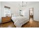 Bright bedroom with hardwood floors, a double bed, and a doorway to the ensuite bathroom at 245 Tumbling River Dr, Wendell, NC 27591