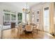 Dining room with hardwood floors, statement light fixture, neutral furniture, leading to outdoor patio at 245 Tumbling River Dr, Wendell, NC 27591