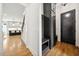 Welcoming entryway with built-in storage and bench seating next to a sleek, modern black door at 245 Tumbling River Dr, Wendell, NC 27591
