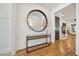 Elegant foyer featuring hardwood floors, a modern console table, and large mirror at 245 Tumbling River Dr, Wendell, NC 27591