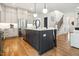 Modern kitchen boasts a large island, stainless steel appliances, and open layout at 245 Tumbling River Dr, Wendell, NC 27591