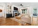 Cozy living room features a fireplace, hardwood floors, and custom built-ins at 245 Tumbling River Dr, Wendell, NC 27591