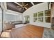 Spacious screened-in porch with wood floors, fan, comfortable seating and views of backyard at 245 Tumbling River Dr, Wendell, NC 27591