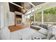 Screened-in porch with vaulted ceilings, a fireplace, fan, TV, and comfortable seating at 245 Tumbling River Dr, Wendell, NC 27591