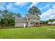 The backyard features lush greenery and ample space for recreation and gardening at 248 Robin Loop, Dunn, NC 28334