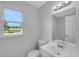 Bathroom showcasing a single sink vanity and a view of the private backyard at 248 Robin Loop, Dunn, NC 28334
