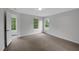 Neutral bedroom featuring plush carpeting, white walls, and natural light from large windows at 248 Robin Loop, Dunn, NC 28334