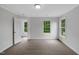 Neutral bedroom featuring plush carpeting, white walls, and natural light from large windows at 248 Robin Loop, Dunn, NC 28334