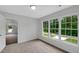 Bedroom featuring neutral carpet, a large window, and direct access to additional room at 248 Robin Loop, Dunn, NC 28334