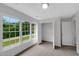 Bright bedroom with closet, neutral carpet, and large windows offering backyard views at 248 Robin Loop, Dunn, NC 28334