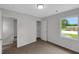 Bedroom features a large window, neutral paint, carpet flooring, and an open closet for storage at 248 Robin Loop, Dunn, NC 28334