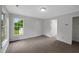 Bright bedroom featuring neutral walls, soft carpet, and a window overlooking the yard at 248 Robin Loop, Dunn, NC 28334