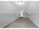 Large, carpeted bonus room with neutral paint and lighting, offering versatile space at 248 Robin Loop, Dunn, NC 28334