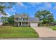 Charming two-story home with an attached garage, inviting front porch, and well-manicured lawn at 248 Robin Loop, Dunn, NC 28334