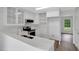 Modern kitchen featuring stainless steel appliances, white cabinets, and open shelving at 248 Robin Loop, Dunn, NC 28334