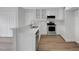 Modern kitchen featuring stainless steel appliances, white cabinets, and a breakfast bar at 248 Robin Loop, Dunn, NC 28334
