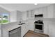 Modern kitchen featuring stainless steel appliances, white cabinets, and quartz countertops at 248 Robin Loop, Dunn, NC 28334