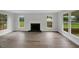 Bright living room with wood floors, fireplace, and large windows offering views of the yard at 248 Robin Loop, Dunn, NC 28334