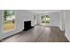 Bright living room with wood floors, fireplace, and large windows offering views of the yard at 248 Robin Loop, Dunn, NC 28334