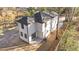 Aerial view of a two-story house with white siding and black framed windows and back patio at 2513 Rochelle St, Durham, NC 27703