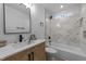 Stylishly renovated bathroom featuring modern vanity, and shower over tub with marble style tile at 2513 Rochelle St, Durham, NC 27703