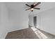 Bright bedroom featuring neutral carpet and natural light, plus a painted gray door at 2513 Rochelle St, Durham, NC 27703