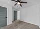 Simple bedroom featuring neutral-colored walls, carpet, a ceiling fan, and large closet at 2513 Rochelle St, Durham, NC 27703