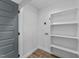 Small laundry area featuring connections, shelving and a gray painted door at 2513 Rochelle St, Durham, NC 27703