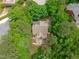 Aerial view of house surrounded by dense foliage, a manicured lawn, and private driveway at 297 Curragh Cv, Fuquay Varina, NC 27526