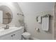 This bathroom includes stylish fixtures, decorative foliage, and a modern, neutral color scheme at 297 Curragh Cv, Fuquay Varina, NC 27526