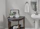 Powder room with pedestal sink and decorative accents at 297 Curragh Cv, Fuquay Varina, NC 27526