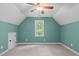Cozy bedroom featuring neutral carpeting, a vaulted ceiling and a large window offering natural light at 297 Curragh Cv, Fuquay Varina, NC 27526