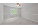 Spacious bedroom featuring a neutral paint and carpet, plus a large window at 297 Curragh Cv, Fuquay Varina, NC 27526