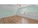 This bonus room features fresh paint, a ceiling fan, wood floors, built-in cabinets, and a window bench at 297 Curragh Cv, Fuquay Varina, NC 27526
