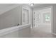 Bright hallway with neutral carpet and paint, leading to multiple rooms at 297 Curragh Cv, Fuquay Varina, NC 27526