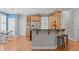 Eat-in kitchen featuring wood floors, stainless appliances, and island with seating at 297 Curragh Cv, Fuquay Varina, NC 27526