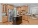 Spacious kitchen featuring stainless steel appliances, custom cabinets, and center island at 297 Curragh Cv, Fuquay Varina, NC 27526
