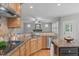 Open-concept kitchen with granite countertops and stainless steel appliances at 297 Curragh Cv, Fuquay Varina, NC 27526