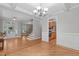 Open-concept living space showcasing hardwood floors, staircase, and a glimpse into the kitchen with modern appliances at 297 Curragh Cv, Fuquay Varina, NC 27526