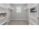 Well-organized walk-in closet with shelves, rods, and natural light from a window at 297 Curragh Cv, Fuquay Varina, NC 27526