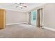 The main bedroom offers a ceiling fan, plush carpet, natural light, and large window at 3004 Krogen Ct, Creedmoor, NC 27522