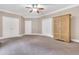 Spacious carpeted bedroom featuring a ceiling fan, neutral walls, and closet space at 3004 Krogen Ct, Creedmoor, NC 27522
