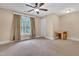 Spacious bedroom features a ceiling fan, large window for natural light, and neutral carpeting at 3004 Krogen Ct, Creedmoor, NC 27522