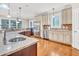 Bright and spacious kitchen featuring granite countertops, stainless steel appliances, and hardwood floors at 3004 Krogen Ct, Creedmoor, NC 27522