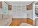 Bright living room with hardwood floors features arched, built-in shelving and wainscotting at 3004 Krogen Ct, Creedmoor, NC 27522