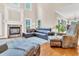 Bright living room with stone fireplace, wood floors, and a leather sectional couch at 3004 Krogen Ct, Creedmoor, NC 27522