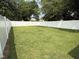 Spacious backyard enclosed by a tall white fence, perfect for outdoor activities and privacy at 306 W Canary St, Dunn, NC 28334