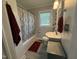 Bathroom with grey walls, storage, and a combination shower and bathtub at 306 W Canary St, Dunn, NC 28334